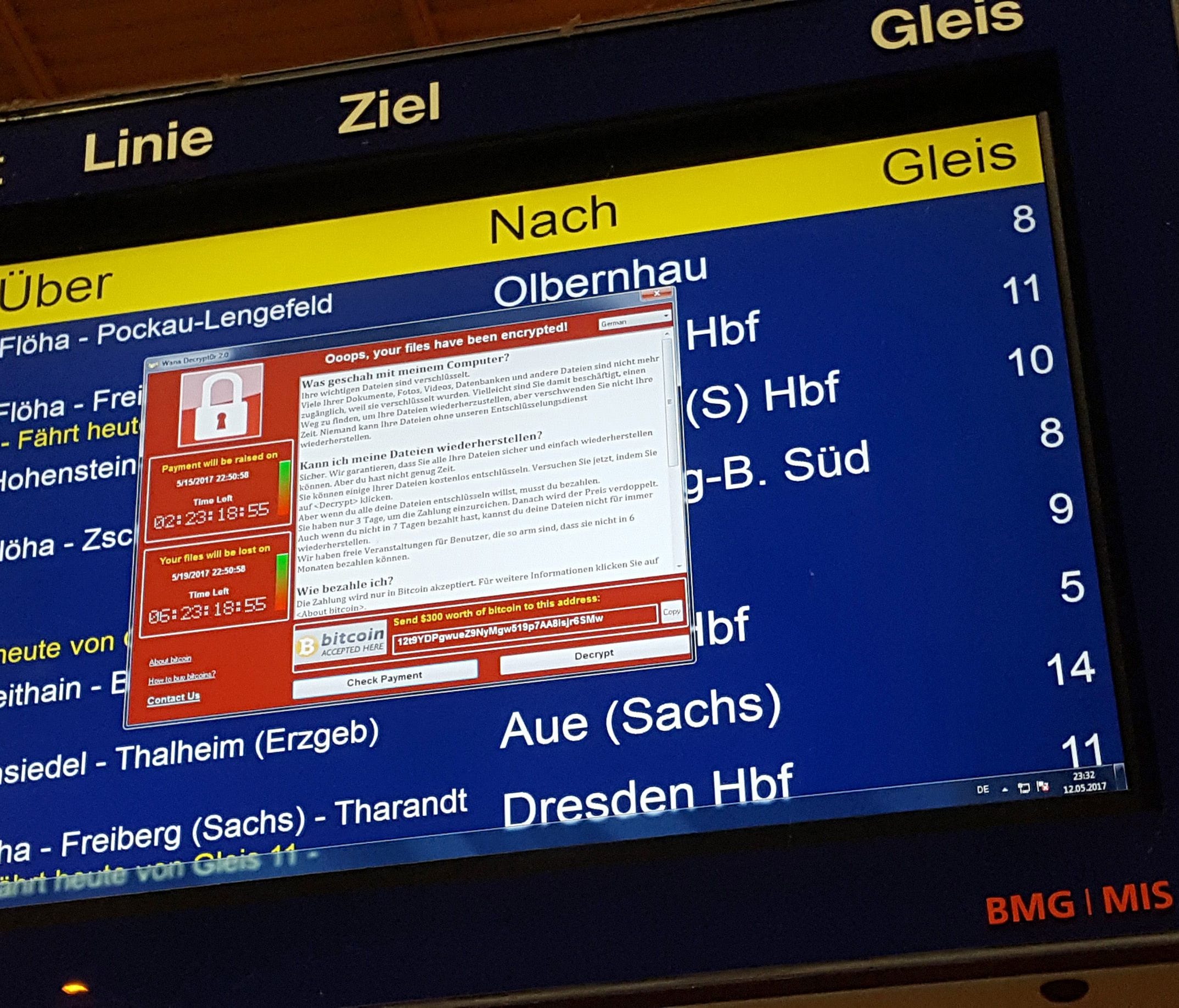 A window announcing the encryption of data including a requirement to pay appears on an electronic timetable display at the railway station in Chemnitz, eastern Germany, on May 12, 2017.  A fast-moving wave of cyberattacks swept the globe, apparently 
