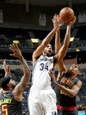 Memphis Grizzlies Brandan Wright (center) shoots defended by Atlanta Hawks Malcolm Delaney (left) and Walter Tavares (right) during the preseason game at FedExForum on Oct. 6.