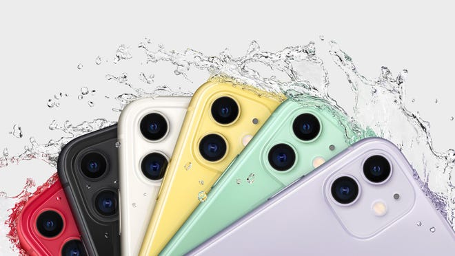The iPhone 11 in six different colors fanned with water splashing emphasizing water resistance.