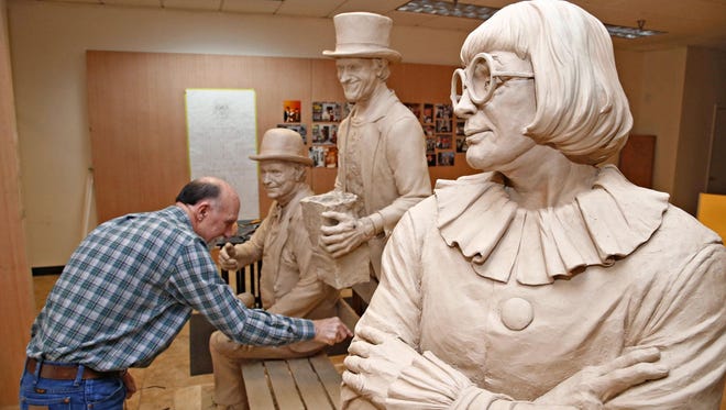 Sculptor Neil Logan works on his sculpture of Wallace and Ladmo in a downtown studio space.