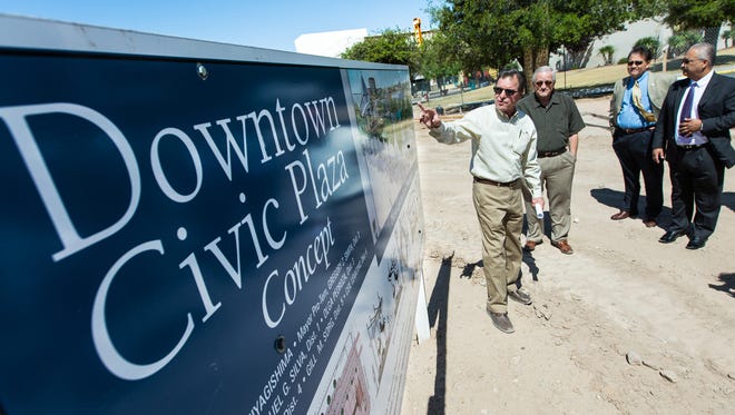 Las Cruces developer Bob Pofahl, center, leads a tour for city officials on Monday, April 25, 2016, of the downtown civic plaza. The project is expected to be completed by August.