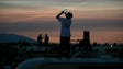 Spectators photograph totality from the roof of their