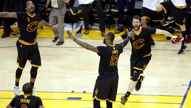 LeBron James celebrates with J.R. Smith and Kevin Love after beating the Golden State Warriors in Game 7of the NBA Finals at Oracle Arena.