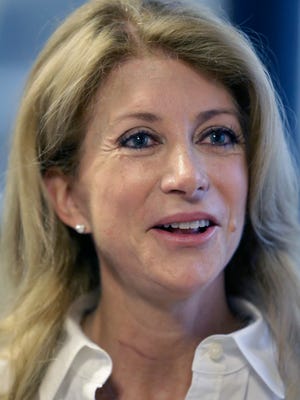 In this file photo, Texas gubernatorial hopeful and state Sen. Wendy Davis speaks to the media at the Texas Democratic Convention in Dallas, Saturday, June 28, 2014. Davis said talk of her underdog bid for Texas governor faces too steep a climb is "absurd." 