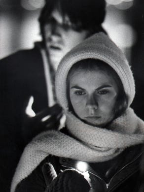 Lisa Bick, 18, Finneytown, shields the flame of her candle from the wind as she and a number of other youths hold a memorial service on Fountain Square Tuesday, Dec, 4, 1979. The group, which marched from the coliseum to the square, had three friends among the 11 who died when the crowd stampeded at the entrance to the coliseum.