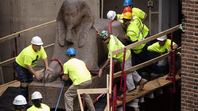 Workers move a 25,000-pound Sphinx of Ramses II Wednesday at the Penn Museum in Philadelphia. The 3,000-year-old sphinx is being relocated from the Egypt Gallery, where it’s resided since 1926, to a featured location in the museum’s new entrance hall.