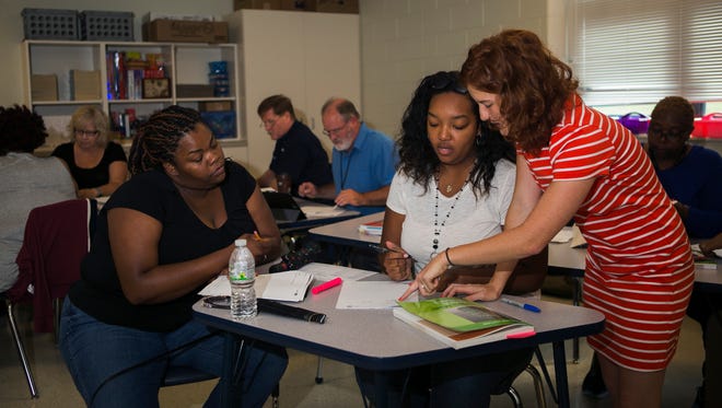 August 2, 2017 - (Left to right) Teachers Candice Eddins, Diamond Butler and Francesca Hall work together during a math session at Kate Bond Middle School on Wednesday. Shelby County Schools has an intense focus this summer on preparing teachers to teach content. In the days leading up to school, educators are spending full days learning the new curriculum and enforcing best practices on state standards.