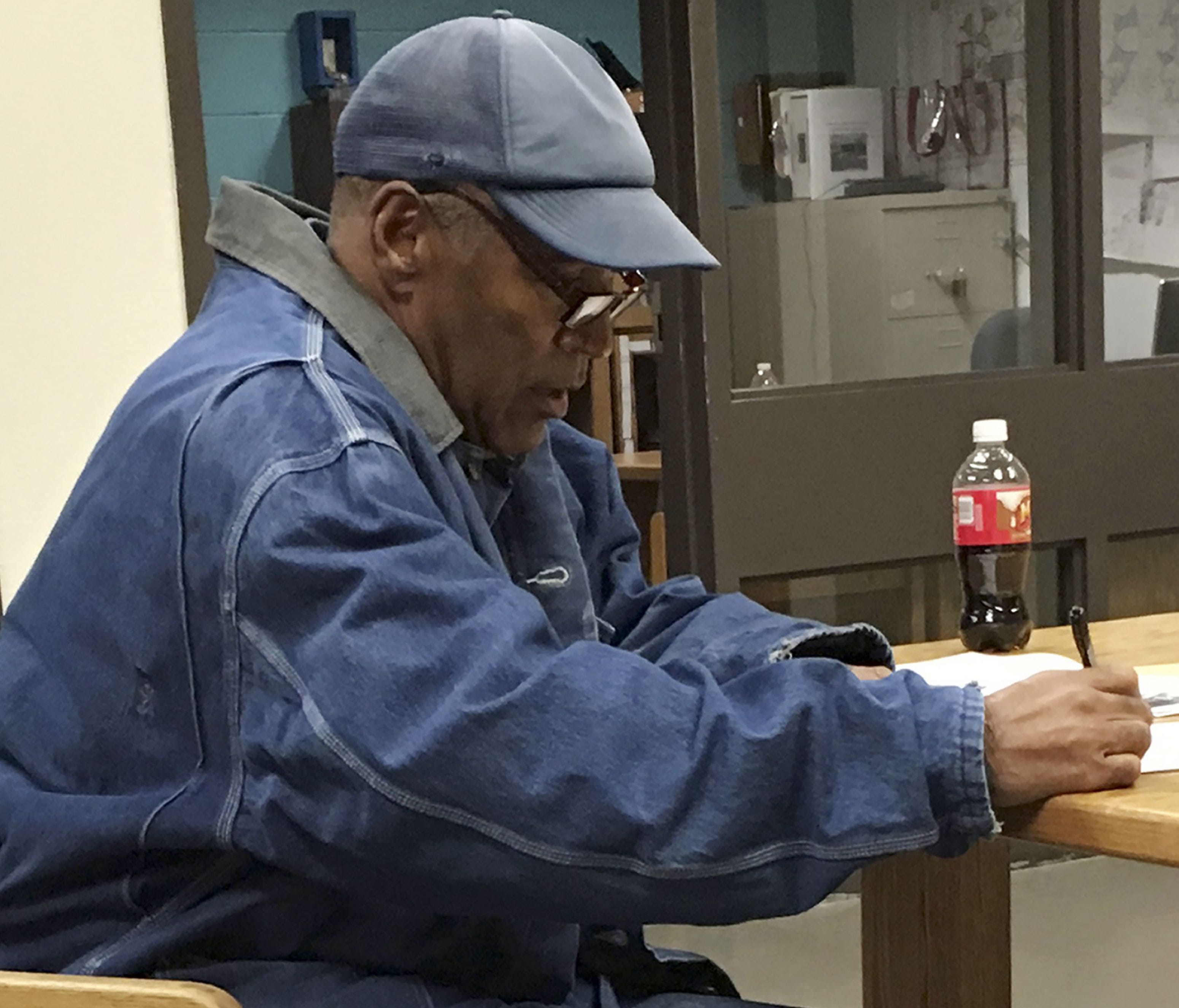 This image released by the Nevada Department of Corrections shows O.J. Simpson signing documents and leaving Lovelock Correctional Centre in Lovelock, Nevada, early on October 1, 2017.