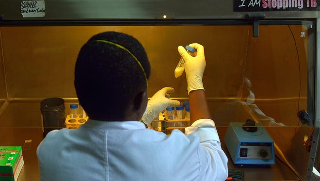 A laboratory technician tests sputum samples for tuberculosis strains at a Medecins Sans Frontieres (MSF)-run clinic in Nairobi, Kenya.