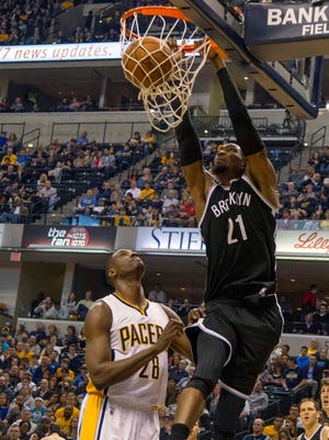 Mar 21, 2015: Brooklyn Nets forward Cory Jefferson (21) dunks the ball over Indiana Pacers center Ian Mahinmi (28) in the second quarter of the game at Bankers Life Fieldhouse.