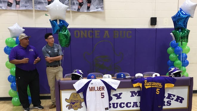 Miller senior pitcher A.G. Ayala (right) spoke with baseball coach Rey Castaneda at the Miller High School gym before signing with Texas A&M-Corpus Christi on Wednesday.