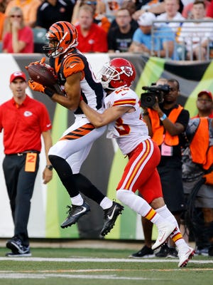 Cincinnati Bengals wide receiver Josh Malone (80) leaps to make a catch ahead of Kansas City Chiefs cornerback Phillip Gaines (23) in the second quarter of the NFL Preseason Week 2 game between the Cincinnati Bengals and the Kansas City Chiefs at Paul Brown Stadium in downtown Cincinnati on Saturday, Aug. 19, 2017. At halftime the Bengals trailed 16-9.