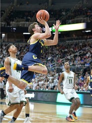 Clarkston junior guard Foster Loyer goes up for a shot