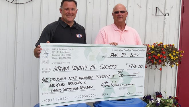 Mike Libben, left, Ottawa County Soil and Water Conservation district program administrator, and Jim Sass,                 Ottawa County Commissioner and OSS board president, display a check for $1,916 awarded for a recycling project.
