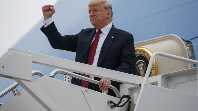FILE - In this Sept. 21, 2018, file photo, President Donald Trump gestures as he arrives at Springfield-Branson National Airport before attending a campaign rally in Springfield, Mo.