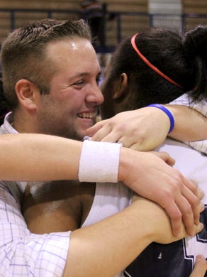 West coach Eddie Gambrell, center, gets hugs from his players including Alexus Patterson, right, on Wednesday, March 2, 2011 after beating Farragut to win the Region 2-AAA championship game at West High School.