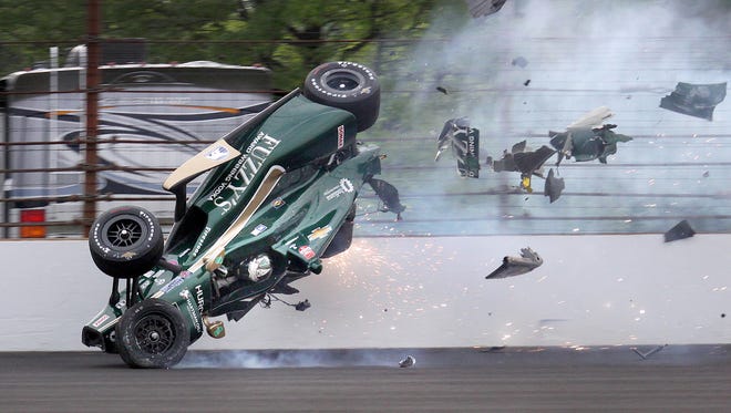 Ed Carpenter (20) of CHF Racing hits the wall coming out of turn 2 and goes airborne during the morning practice on Pole Day for the Indianapolis 500 Sunday, May 17, 2015, at the Indianapolis Motor Speedway.