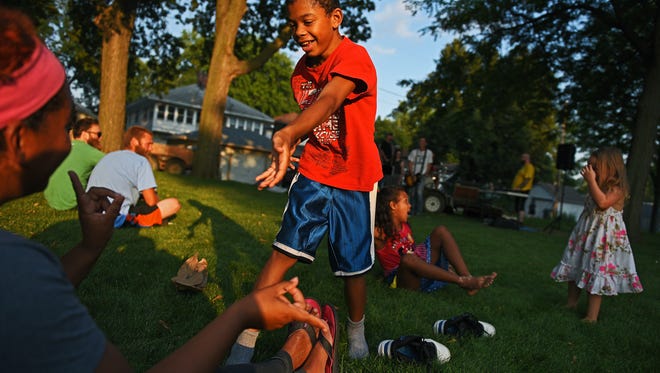 William Colon, 13, dances with his mom, Wendy Harty, both of Sioux Falls, during a National Night Out event Tuesday, Aug. 2, 2016, at Lyon Park in Sioux Falls. 