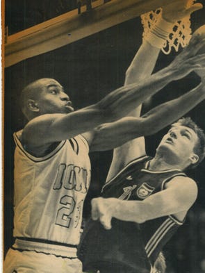 Roy Marble goes underneath the basket and the outstretched arm of a Yugo-slav defender during the first half of Iowa's rout on Thursday.
