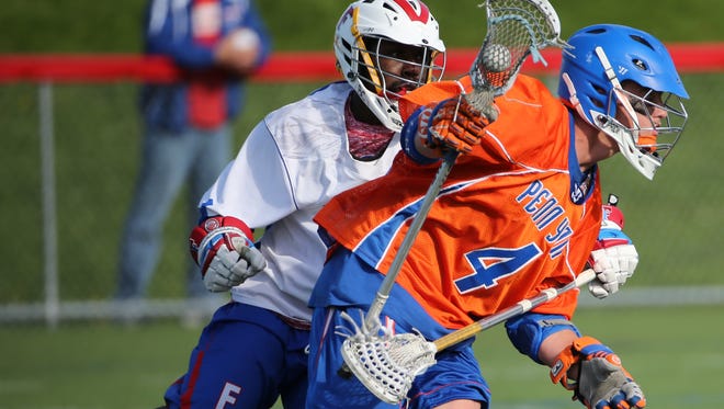 Penn Yan’s Austin Fingar (4) and Fairport’s Jahadi Prior in lacrosse action Tuesday at Fairport. Penn Yan won 10-7 thanks to three goals and an assist from Fingar.