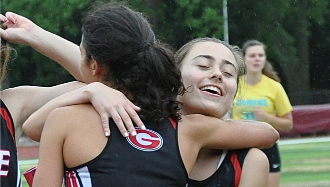 Rye sophomore Natalie Weiner (l) hugs senior teammate Andrea Palu (r) after Palu ran her last race for Rye..