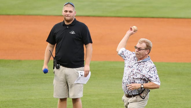 Rusty Schrivner, son of the late Billy Schrivner, throws out the first pitch at the Billy Schrivner West Tennessee all-star baseball game Wednesday.