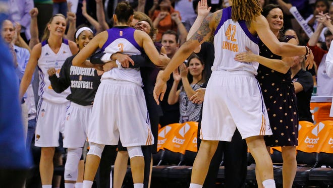 The Phoenix Mercury celebrate their 96-78 win over the Minnesota Lynx  in game 3 of the WNBA Western Conference finals Tuesday, Sept. 2,  2014 in Phoenix  Ariz.