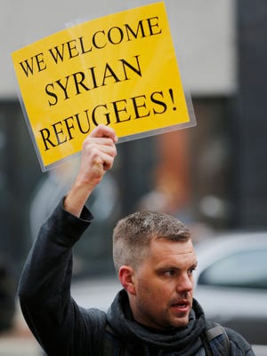Jonas Ecke joins in the protest of Gov. Mike Pence's ban on Syrian refugees entering the state Friday, December 4, 2015, at the Tippecanoe County Courthouse in downtown Lafayette. About 70 people, including members of the Lafayette chapter of Indiana Moral Mondays, the Purdue Social Justice Coalition, Students for Justice in Palestine, the Lafayette Peace Coalition and others, marched from the Purdue Memorial Union to the Tippecanoe County Courthouse to show that Indiana welcomes refugees.