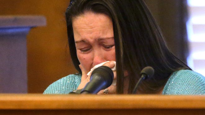 Mary Thomas, the mother of infant Mekhi Cole, reacts to a text conversation that she had with defendant Angela Buchanan while on the stand during Buchanan's first-degree murder trial Wednesday, Feb. 22, 2017.