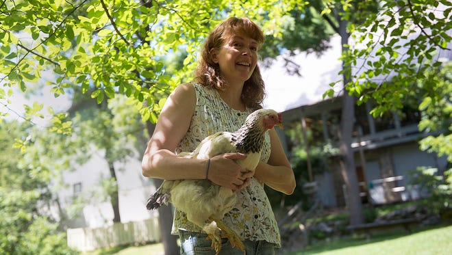 Presenter Beth Lucabaugh of Glen Rock responds to a question from the audience about her 15 years of experience raising chickens during a presentation at the Nixon Park Nature Center in Springfield Township. She is holding a breed of chicken called a Light Brahma.