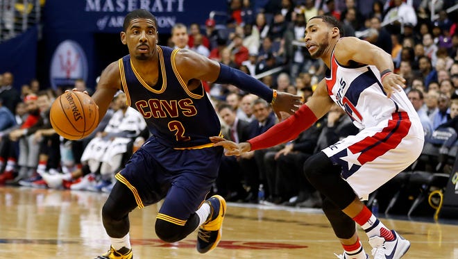 Cleveland Cavaliers guard Kyrie Irving (2) dribbles the ball past Washington Wizards guard Garrett Temple (17) in a recent game.