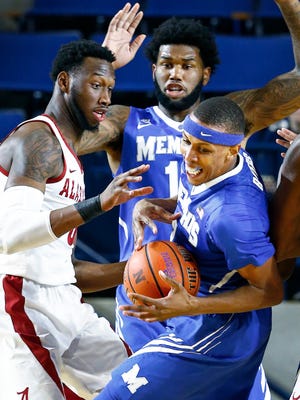 University of Memphis forward Jimario Rivers (right) grabs a loose ball away from University of Alabama center Donta Hall (left) as teammate Mike Parks Jr. (middle) helps defend on the play during first half action at the Veterans Classic  in Annapolis, Md., Friday, November 10, 2017.