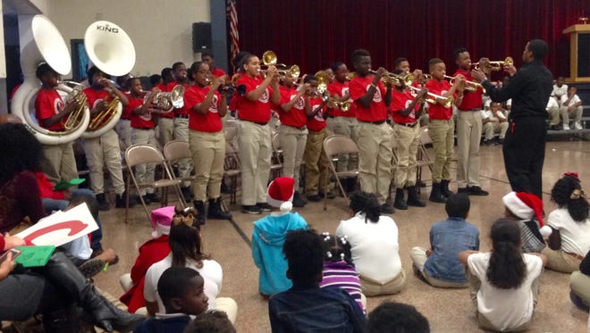Arthur F. Smith Middle Magnet band students perform at W.O. Hall Elementary's Christmas program Wednesday.