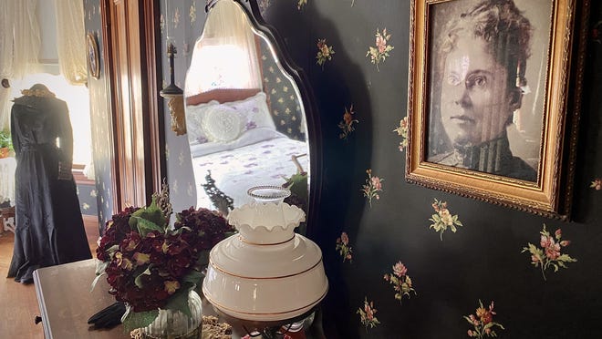 A portrait of a bespectabled Lizzie Borden hangs on the wall of a bedroom inside the Maplecroft house on French Street.