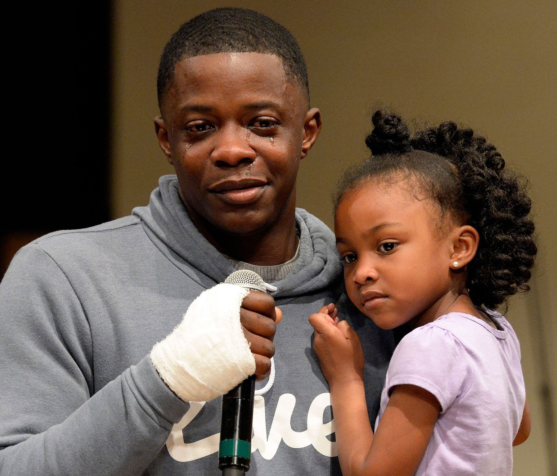 James Shaw Jr. holds his daughter Brooklyn Shaw, 4, while speaking during a prayer vigil at the Mount Zion Baptist Church on Monday, April 23, 2018, in Antioch, Tenn. Civic leaders and residents attended the vigil for those affected by the Sunday, Ap