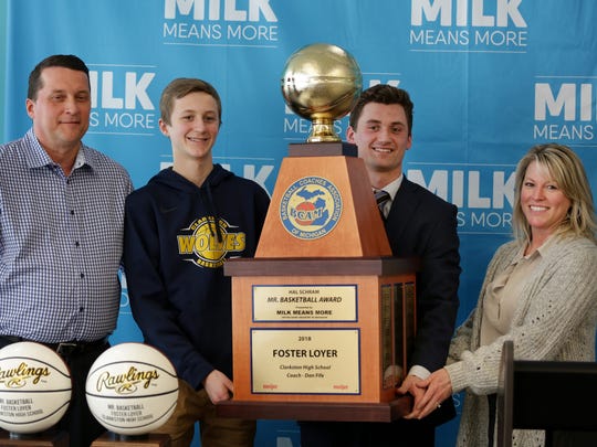 Foster Loyer of Clarkston High School, third from left poses for a photograph with his family, from left father John Loyer, brother Fletcher Loyer and mother Katie Loyer after receiving the 38th annual Hal Schram Mr. Basketball award given by the Basketball Coaches Association of Michigan in Detroit on Monday, March 19, 2018.