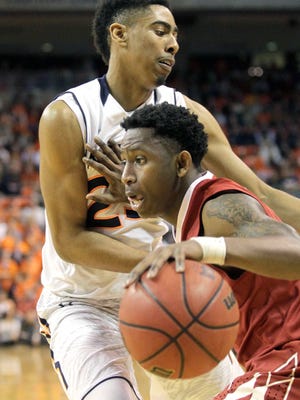 Alabama forward Jeff Garrett pushes Auburn guard TJ Lang out of the way during the first half of a game Feb. 17.
