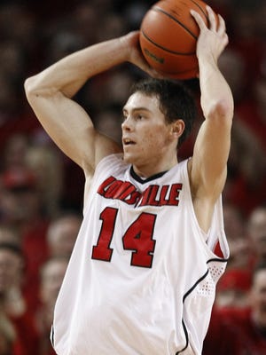 Louisville's Kyle Kuric looks for a teammate to pass to during the second half of their NCAA college basketball game against Syracuse in Louisville, Ky., Saturday, March 6, 2010. Kuric led all scorers with 22 points in the 78-68 Louisville win. (AP Photo/Ed Reinke)