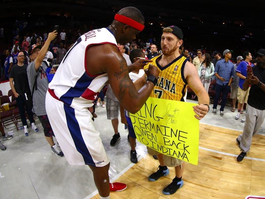 Jermaine O'Neal of Tri-State signs autographs for a