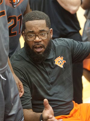 Fern Creek head basketball coach James Schooler, III talks to his players during a time-out.16 December 2016