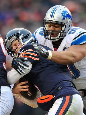 Jimmy Clausen gets sacked by Ndamukong Suh late in the fourth quarter.