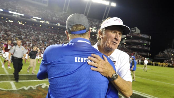 South Carolina coach Steve Spurrier, right, greets Kentucky coach Mark Stoops after an NCAA college football game, Saturday, Oct. 5, 2013, in Columbia, S.C. South Carolina won 35-28. (AP Photo/Rainier Ehrhardt)