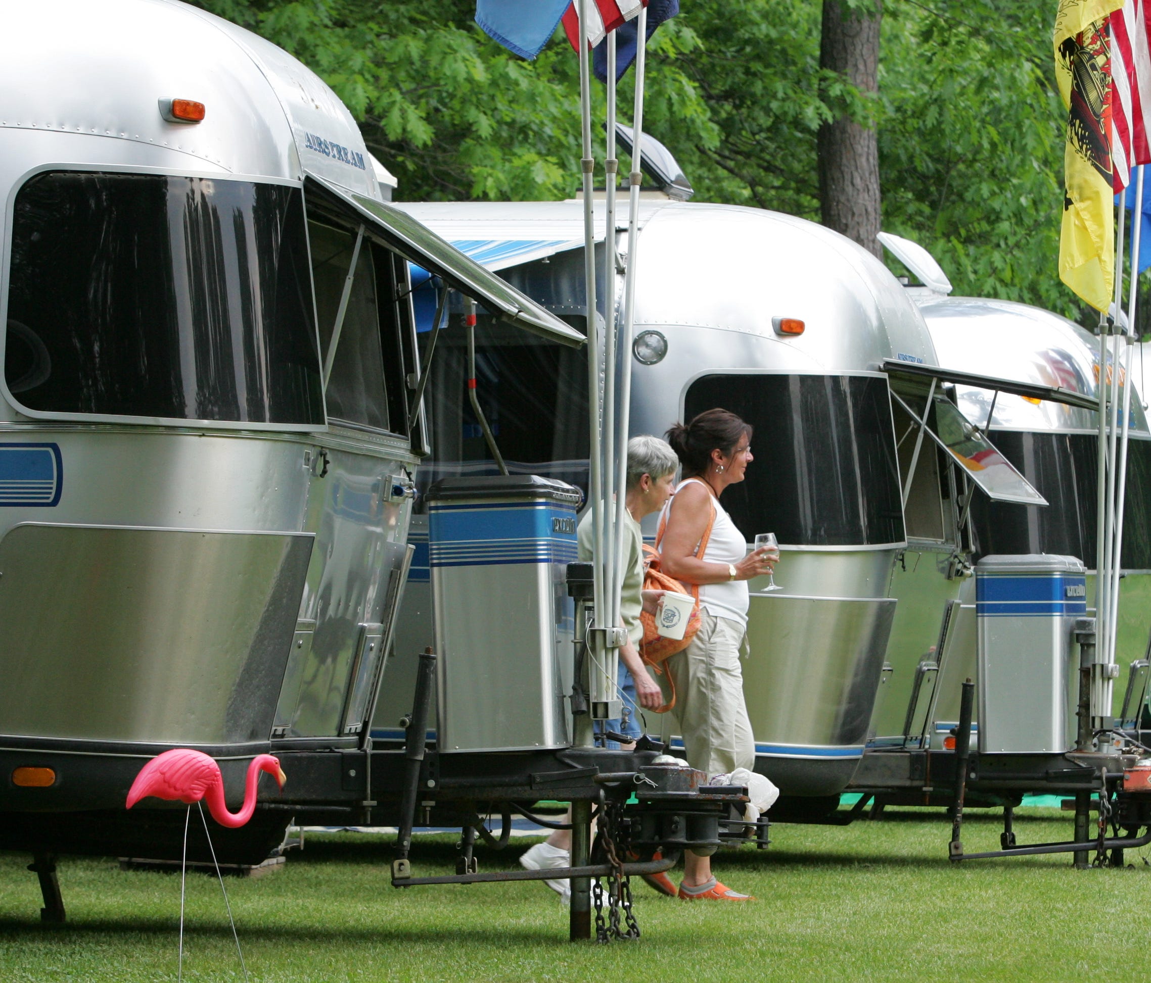 6/1/07 6:17:52 PM -- East Wakefield, NH, U.S.A Airstream Rally Betty Girouard of Winchendon, MA and Elaine Duesel of Marlborough, MA (in white shirt) walk around amidst the Airstream travel trailers parked in the campground at the Lake Forest Resort 