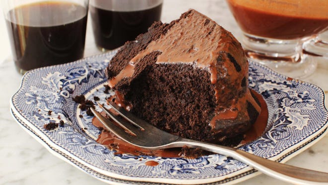 Chocolate Guinness cake is topped with chocolate Guinness glaze. The glaze is an essential part of the cake, as you poke holes in the cake when it is still warm and slowly spoon the glaze over the cake until the holes are filled with it.