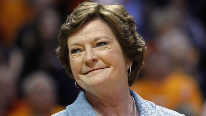 Former Tennessee women’s basketball coach Pat Summitt smiles as a banner is raised in her honor before a game against Notre Dame on Jan. 28, 2013, in Knoxville.