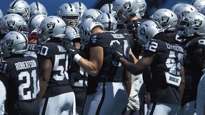 Members of the Las Vegas Raiders huddle up prior to an NFL game against the Carolina Panthers on Sunday, Sept. 13,  in Charlotte, N.C.