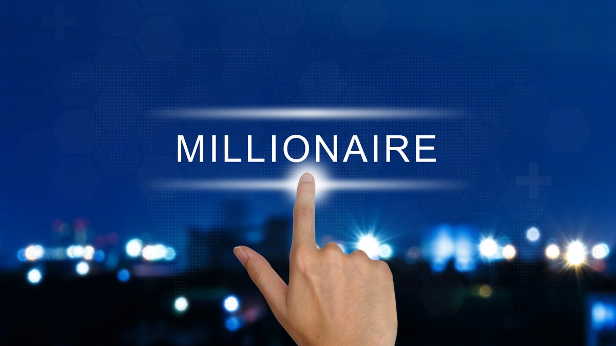 A finger is pointing to the word millionaire.