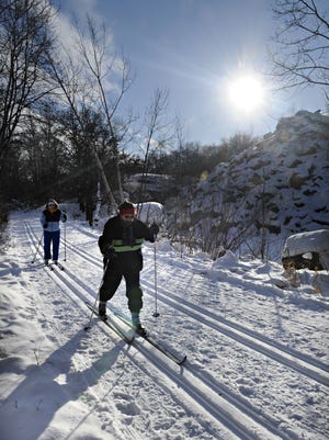 Lori Mueller and Karla Stang ski in January 2013 at Quarry Park & Nature Preserve in Waite Park. The cost of 12-month parking passes increases Jan. 1.