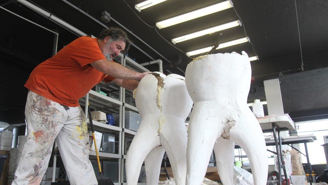 Artist Joe Griffith works on a series of teeth sculptures at the Vester Field Station that is part of a project called “Mercury Switch.”