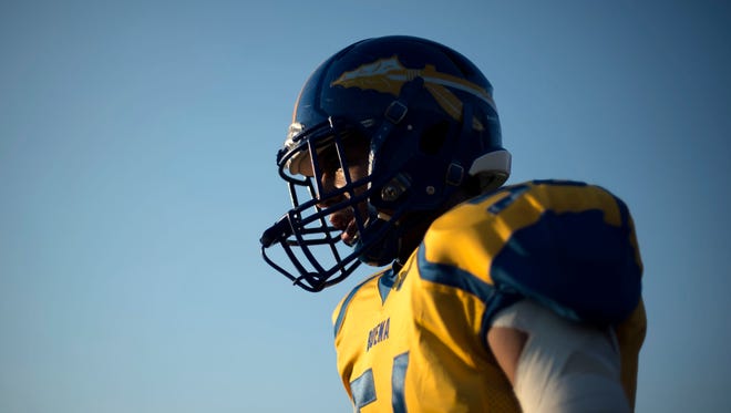 Buena linebacker Eddie Torres heads onto the field as the team practices Friday night before kickoff.